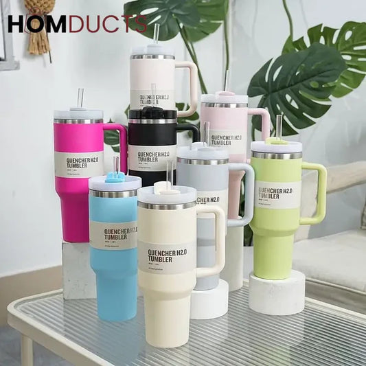 Collection of colorful tumblers with 'HOMDUCTS' branding on a glass table.